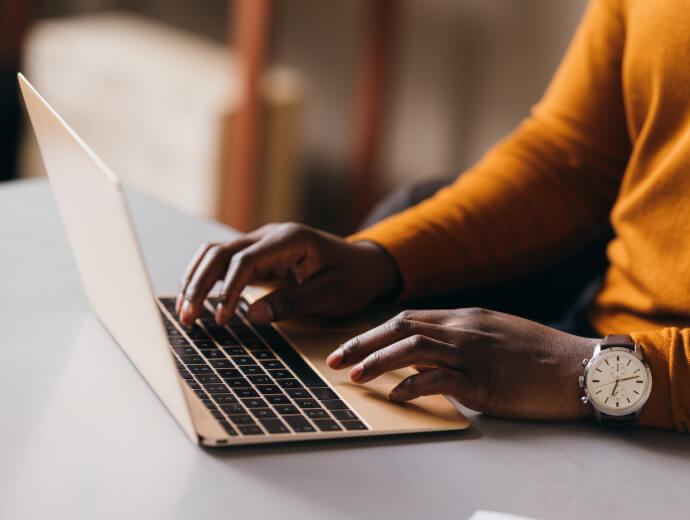 person typing on a laptop keyboard