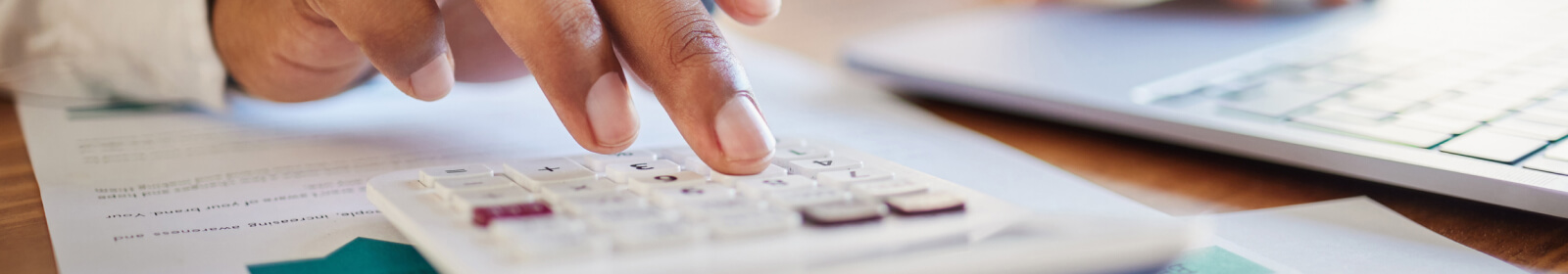 close-up of a hand using a calculator